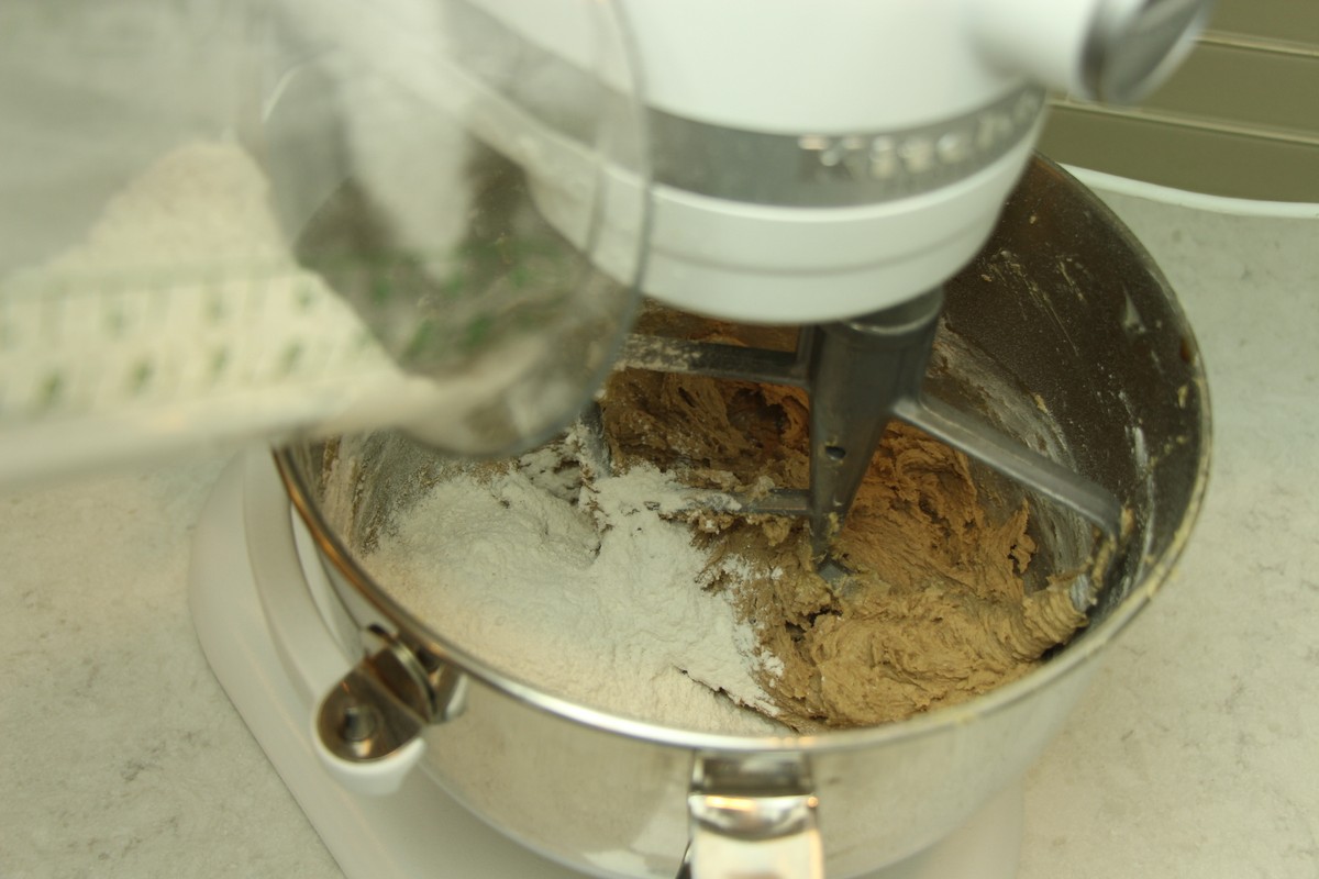 Adding flour to cookie batter, using KitchenAid stand mixer.