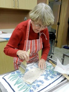 Brushing flour off of lefse