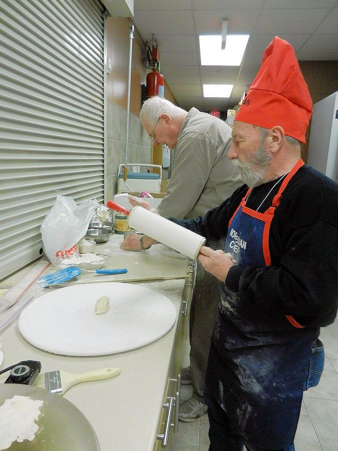 Sprinkling flour onto covered rolling pin