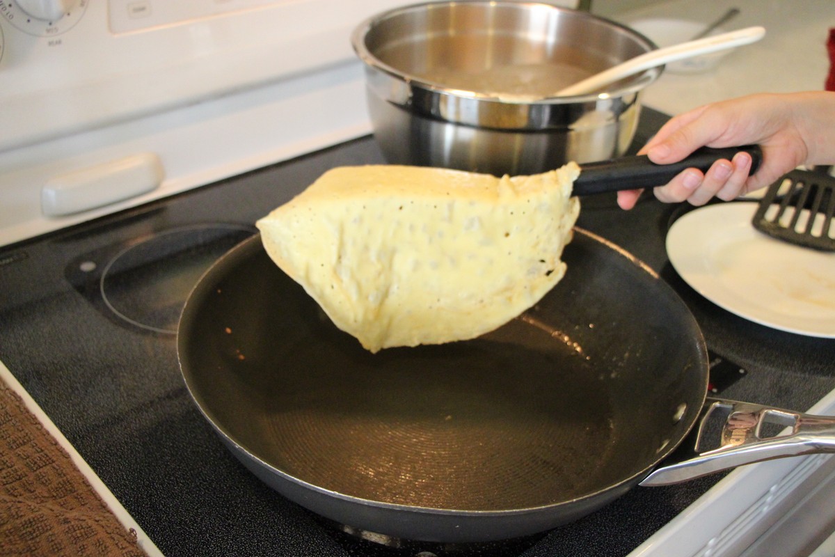 Making thin, authentic Norwegian pancakes, ready to flip