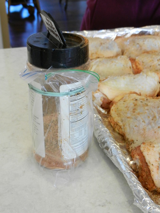 Homemade spice mix for chicken, reusing old container with plastic bag on to keep it clean while working.