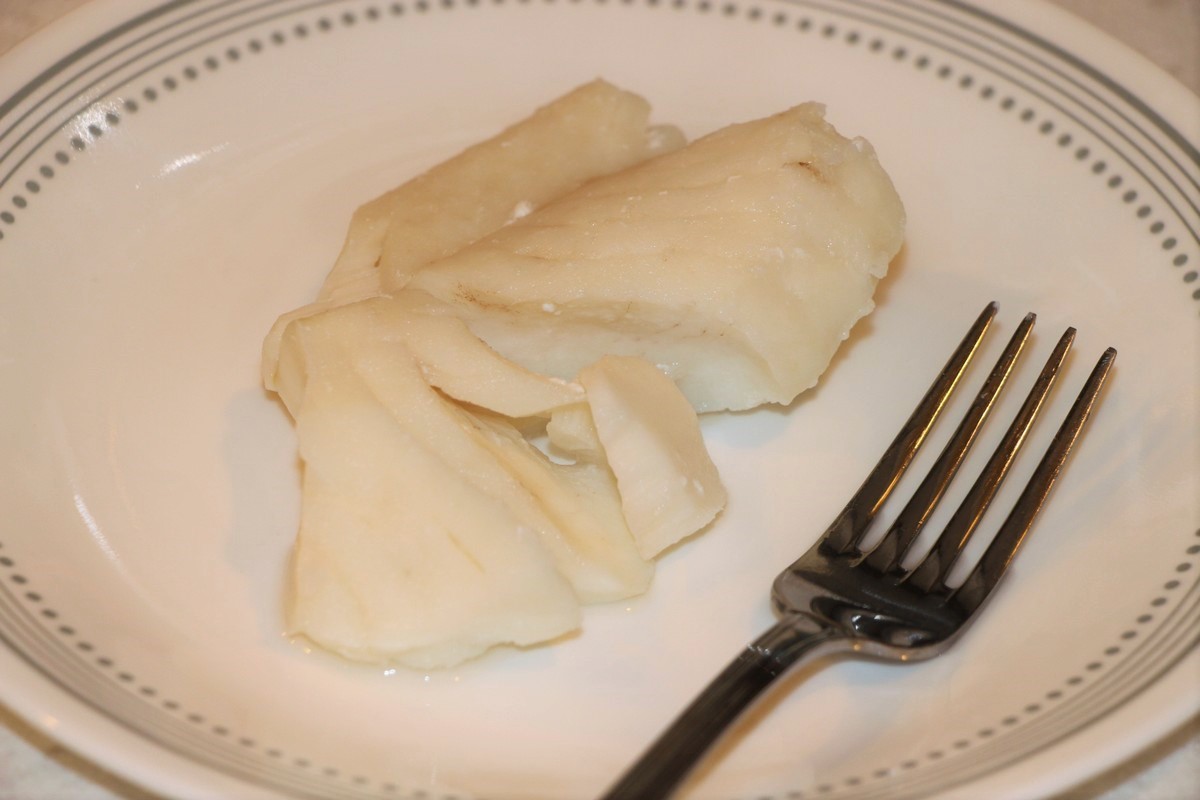 Fish cooked gently until flaky. Cod for use in Norwegian fiskegrateng recipe.