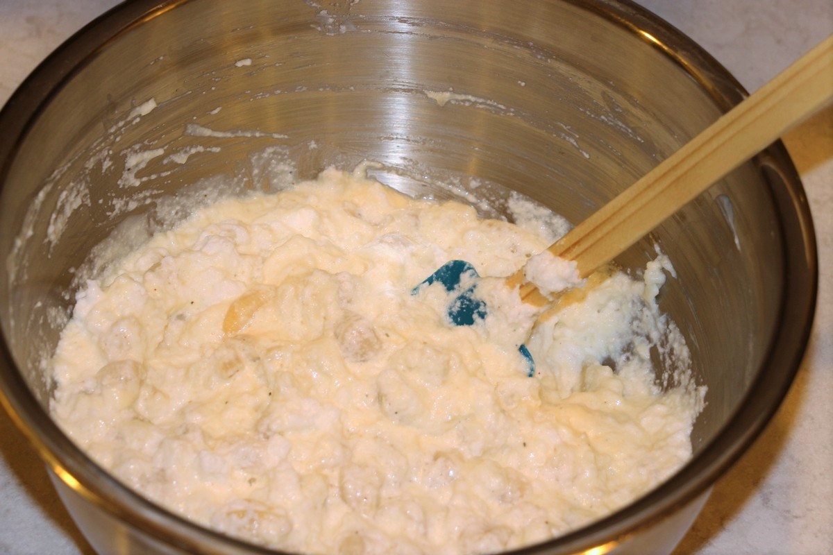 Gently mixing ingredients for Norwegian fish and macaroni casserole, fiskegrateng. Picture tutorial.