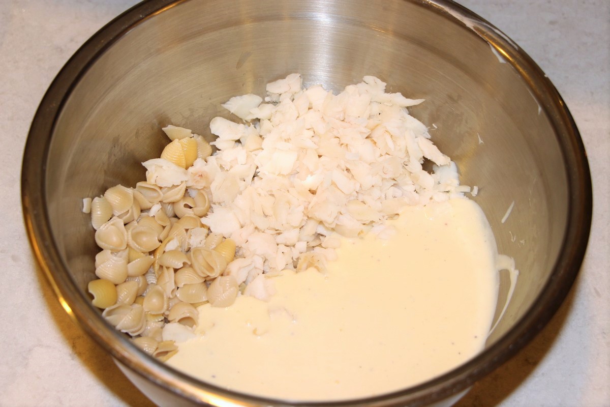 Mixing together fish, macaroni, and roux sauce for Norwegian, traditional fish casserole, fiskegrateng. Recipe.