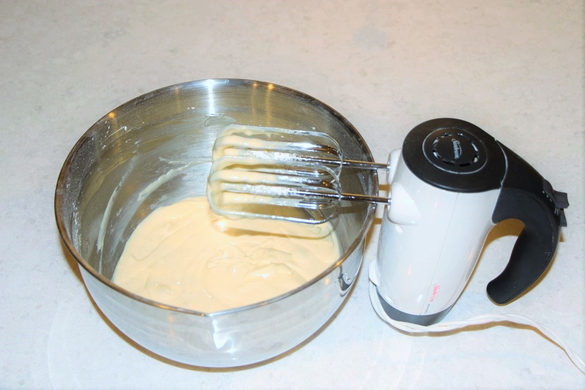 Mixing together ingredients for filling in cream cheese sticky bars. Recipe.