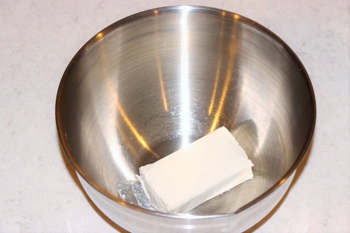 Softening cream cheese in stainless steel bowl.