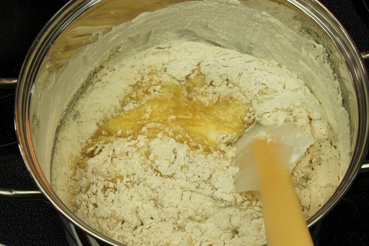 Adding flour mixture to chewy sugar cookies.