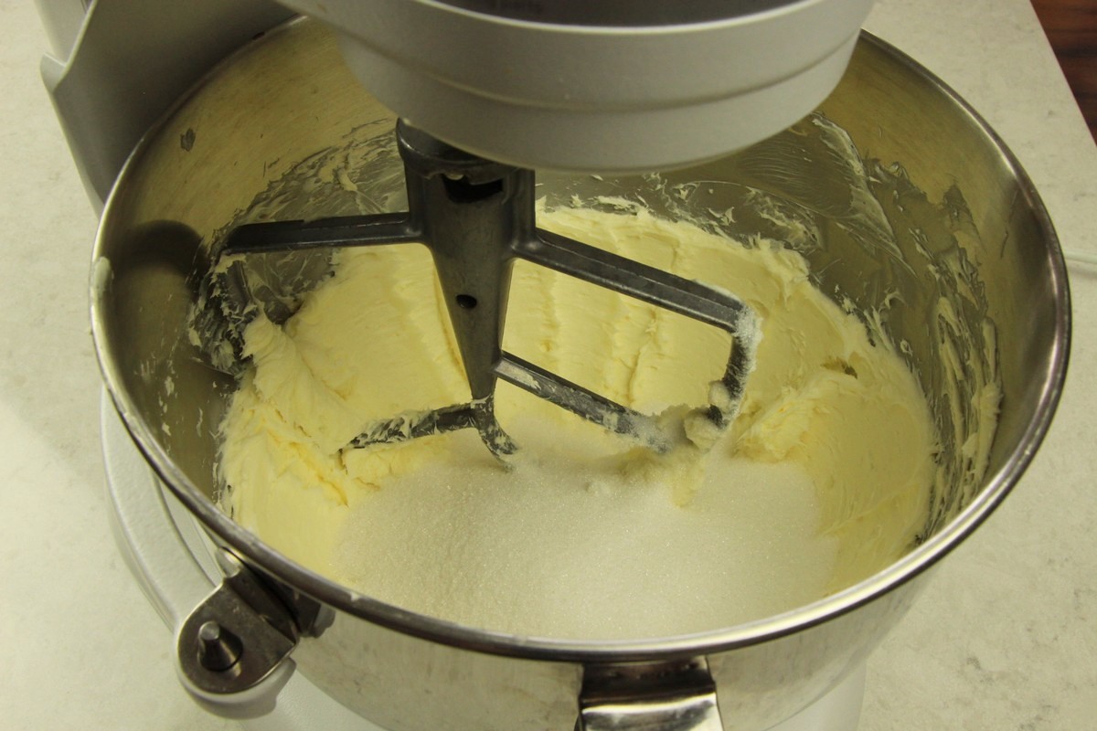Mixing sugar into butter and cream cheese. Sugar cookie batter.