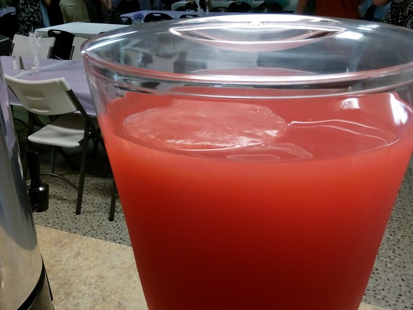 Giant cherry lemonade ice cube to cool down drink in dispenser.