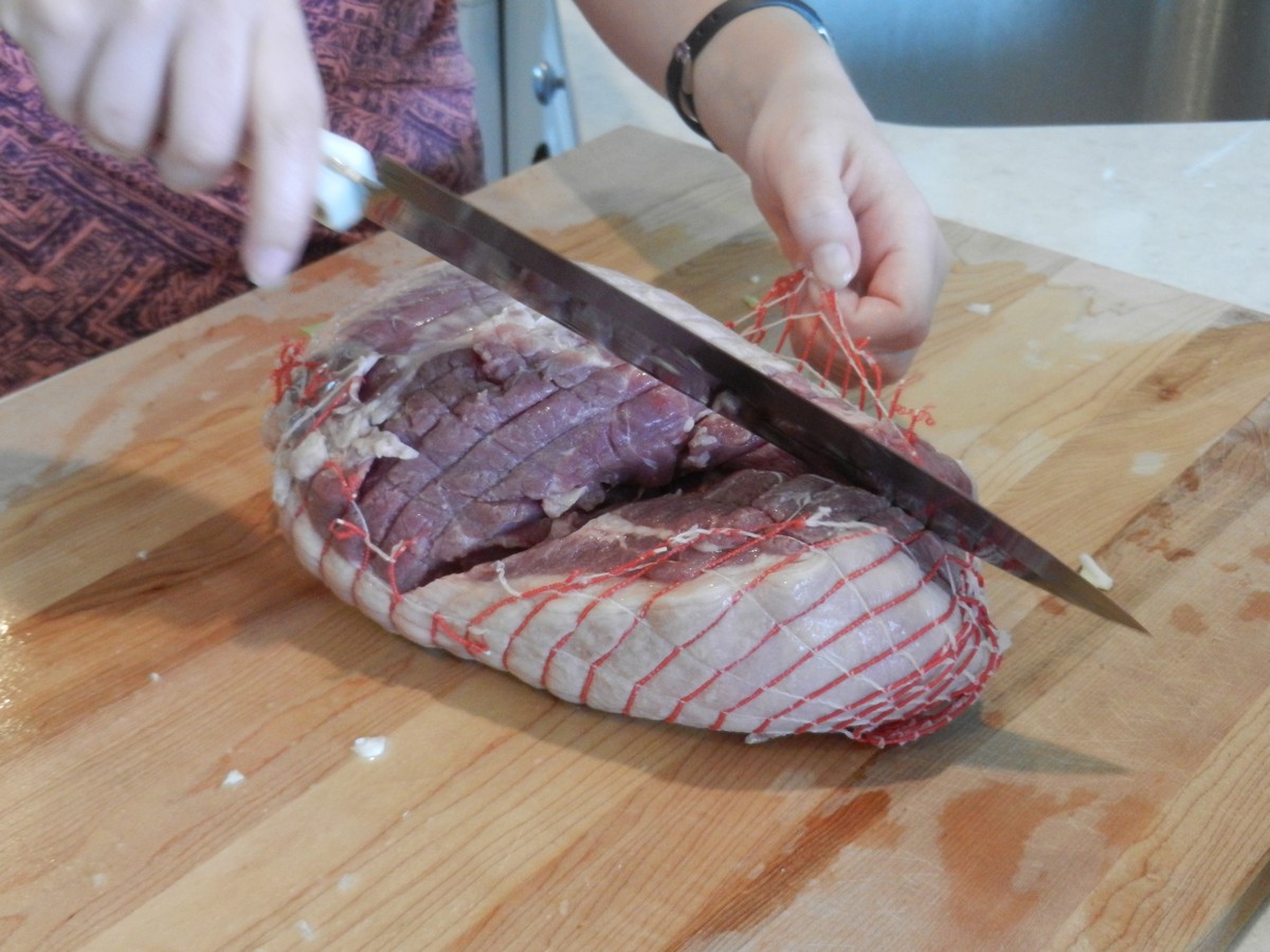 Leg of lamb, cutting off netting. Norwegian lamb dish cooked with cabbage.